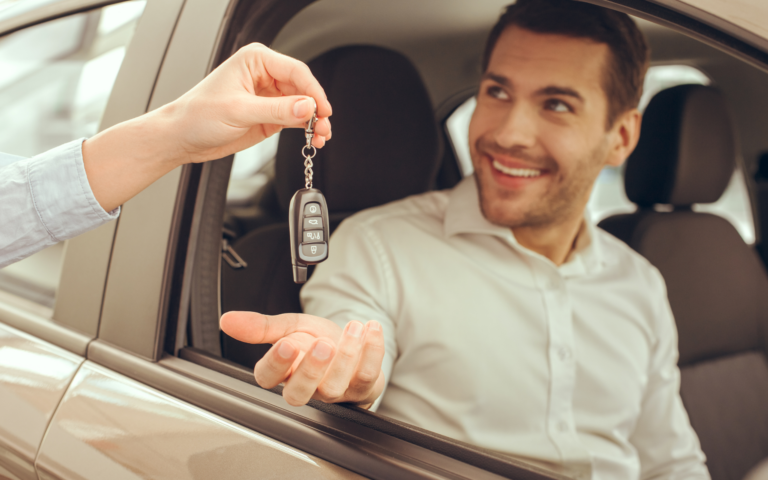 Grinning man receiving car keys
